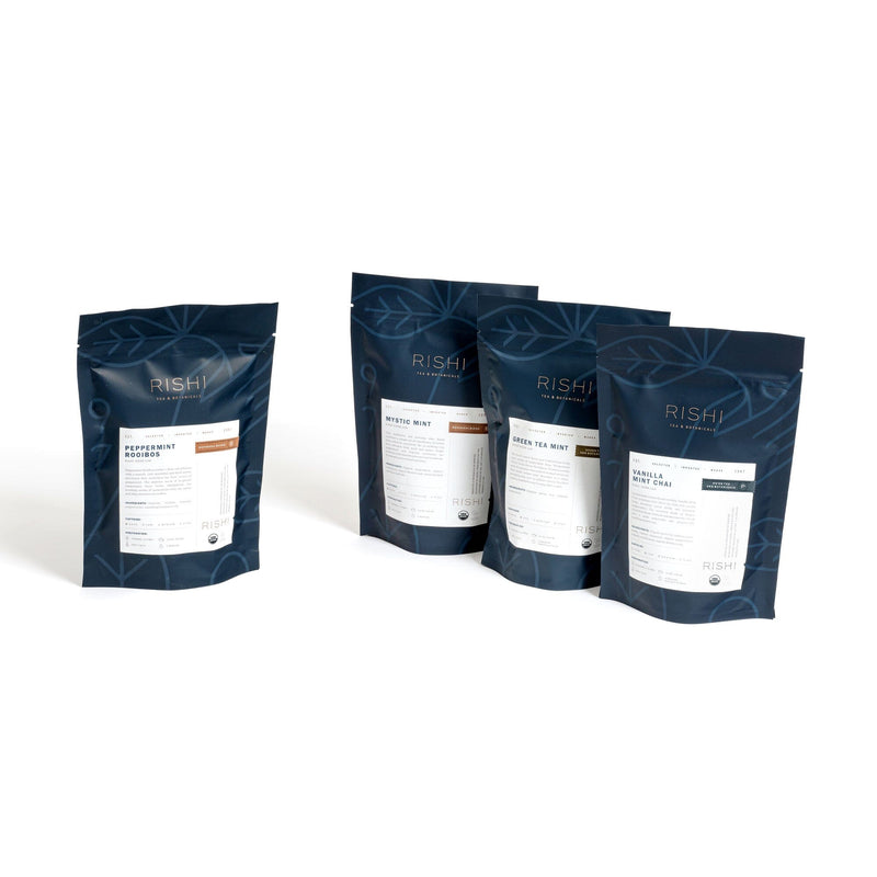 Four bags of Mystic Mint coffee in a row on a white background.