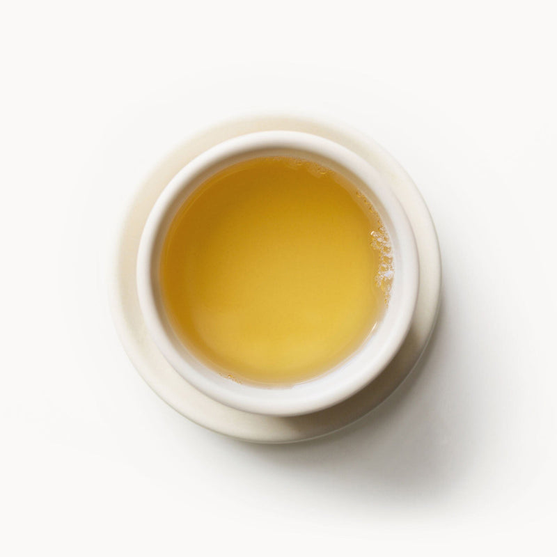 A cup of Rishi Tea & Botanicals ginger tea on a white background.